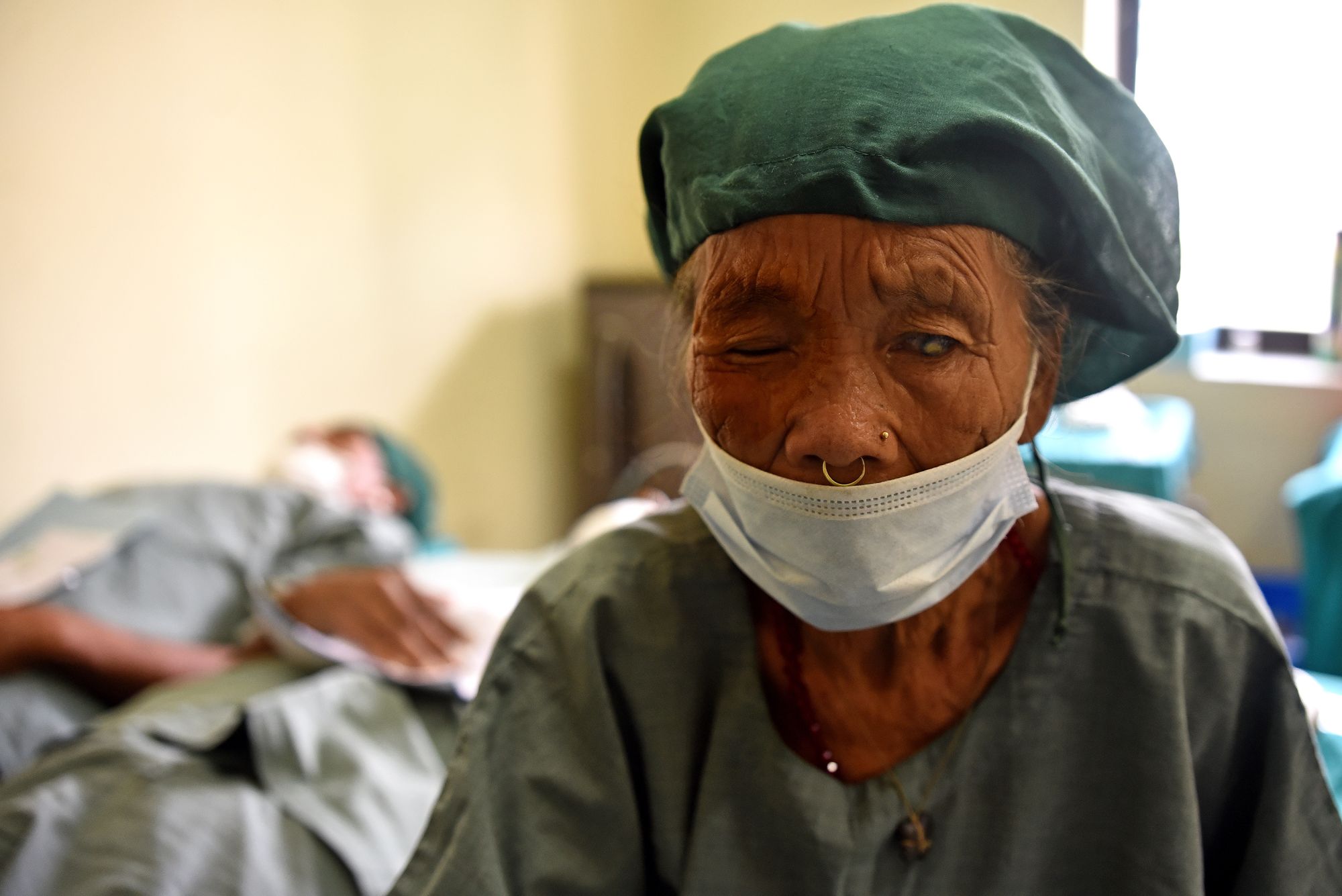 A close up photo of a female patient with cataracts in a hospital room