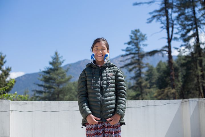 A young girl called Bipana smiling after her cataract surgery.