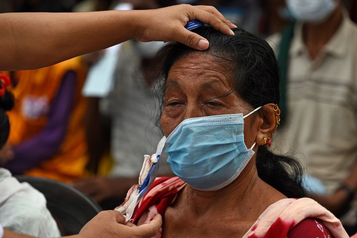 Female patient having her bandages removed at a Tej Kohli & Ruit Foundation outreach camp